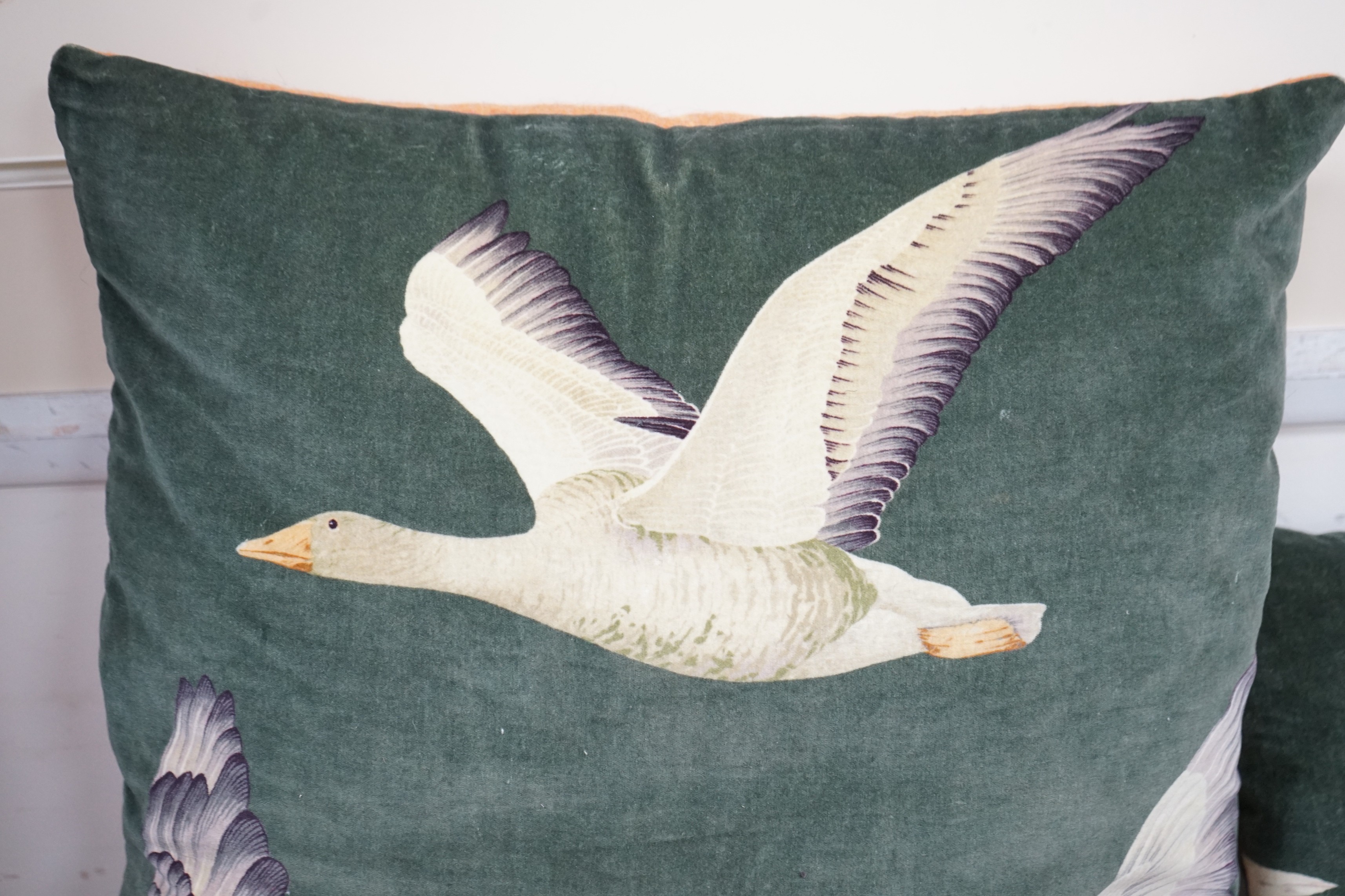 Two pairs of cushions decorated with geese